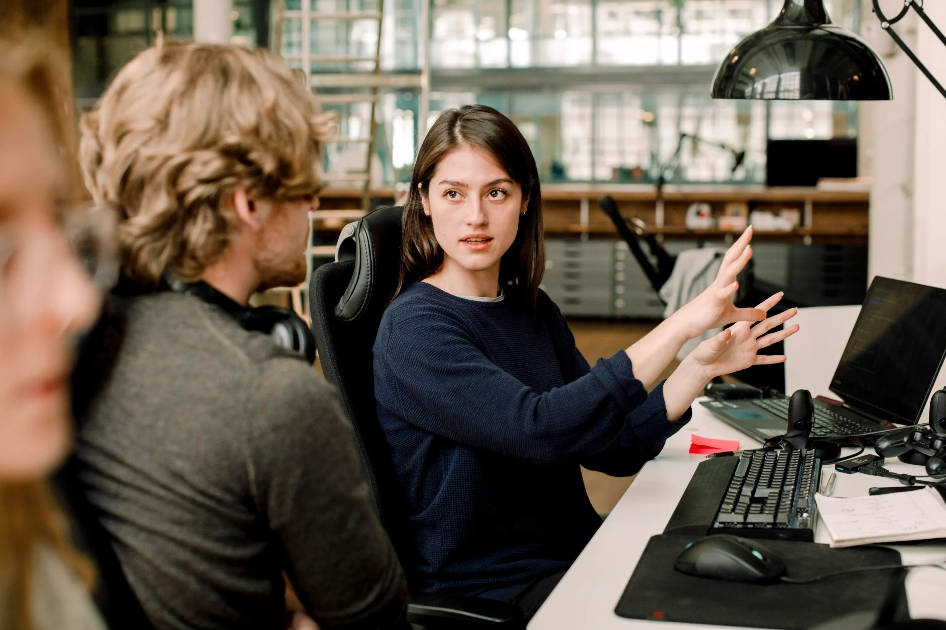 Entrepreneur explaining to colleague while sitting in office